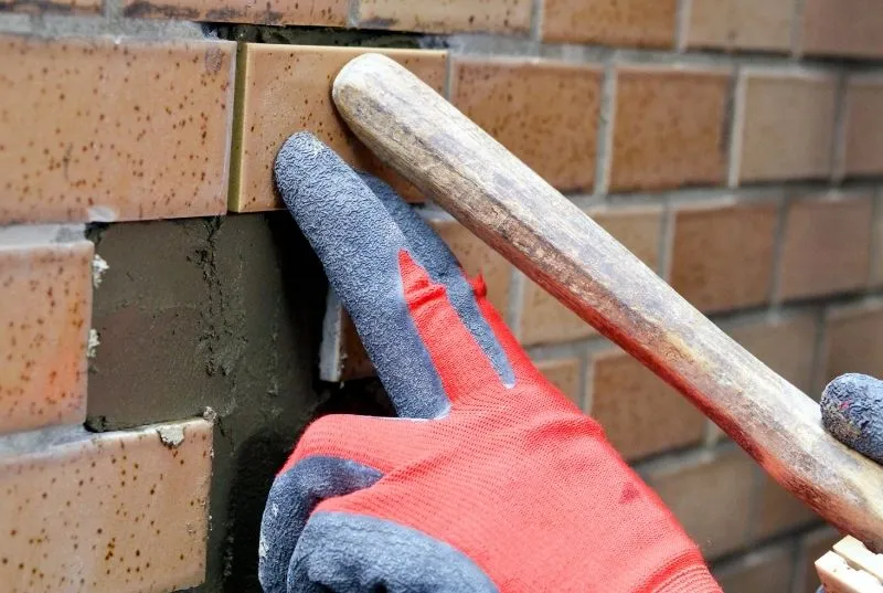 One of our Tilers from Canberra holding a wet terracota tile